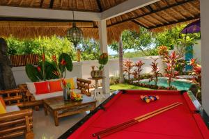 a pool table in a living room with a pool table at Hakuna Matata Bali Villas in Uluwatu +65 photos