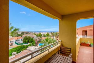 a balcony with a bench and a view of the city at Bellavista Avenida By BeGuest in Albufeira
