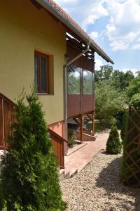 a house with a glass door on the side of it at Aranyos Downhill in Nagymaros