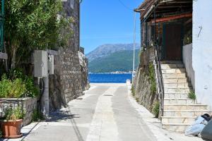 an alley with a view of the water at Apartman UNA in Bjelila