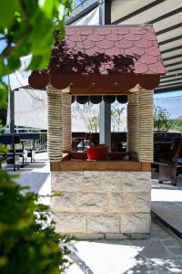 a kiosk with a red roof on a patio at Apartman UNA in Bjelila