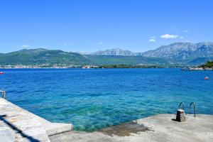 a large body of water with mountains in the background at Apartman UNA in Bjelila +5 photos