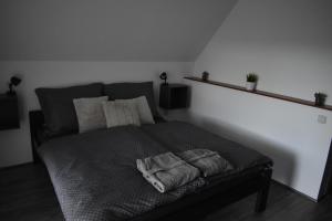 a bed with two towels on it in a room at Aranyos Downhill in Nagymaros