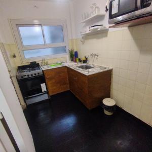 a small kitchen with a sink and a stove at alma in Buenos Aires +8 photos