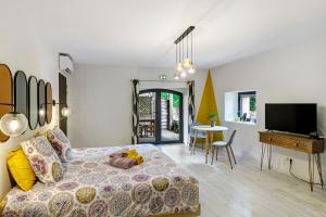 a bedroom with a bed and a tv and a table at Chambres D'hôtes Bien-être Simple in Belvès +85 photos