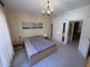 a bedroom with a bed in the middle of a room at Casa vacanze Heidi con piscina in Marina di Bibbona +10 photos