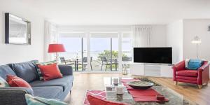 a living room with a couch and a tv at 8 Salt in St Ives