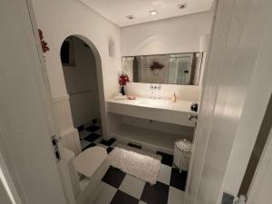 a bathroom with a sink and a mirror at White House Canto in Búzios +33 photos
