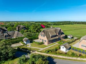 an aerial view of a large house with a roof at Haus Deichblick 2 in Dunsum
