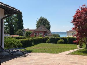 a bench sitting on a patio in front of a house at Casa Constantinus in Unteruhldingen