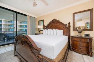 a bedroom with a bed and a mirror at Phoenix on the Bay 1324 in Orange Beach +44 photos