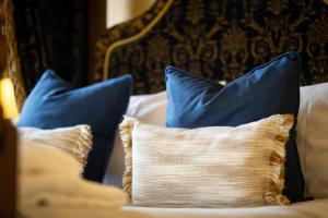 a pillow on a couch with blue pillows at Best Western Red Lion Hotel in Salisbury