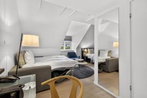 a hotel room with a bed and a mirror at Gentofte Hotel in Gentofte +53 photos