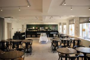 a restaurant with tables and chairs and a bar at Gentofte Hotel in Gentofte