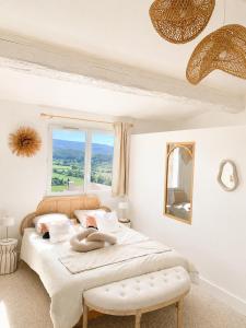 a bedroom with a large bed and a window at Villa Boho Cassis in Cassis