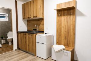 a small kitchen with a sink and a refrigerator at Комплекс Сборяна in Gramatikovo