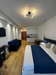 a bedroom with a large bed and a living room at Moonlight Apart-Hotel Batumi in Batumi