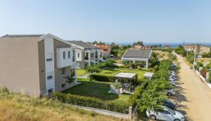 an aerial view of a house with cars parked in a driveway at Bianco Mare Studios-Apartments in Kalives Poligirou