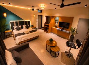 a bedroom with a large bed and a living room at Boho Mount Abu in Mount Ābu