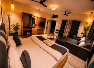 a living room with a large bed and a couch at Boho Mount Abu in Mount Ābu