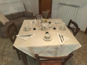 a table with a white table cloth on it at B&B benallonga in Paulilatino