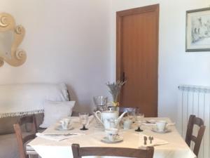 a dining room table with a white table cloth at B&B benallonga in Paulilatino