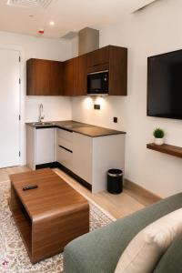 a kitchen with a coffee table in a living room at Soho Residence سوهو ريزيدنس in Kuwait +11 photos