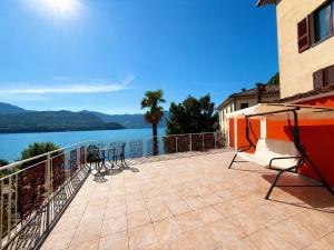 a balcony with chairs and a view of the water at BaB Apartments Tavernola in Tavernola Bergamasca