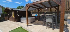 a wooden pavilion with a hot tub in a backyard at Luxury Flat with Heated Pool & Jacuzzi in Rijeka