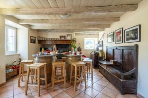 a kitchen with wooden stools and a bar in a room at Sarahandia in Aldudes