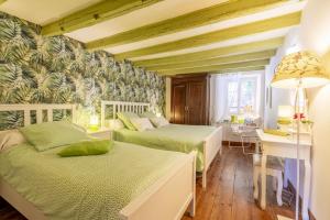 a bedroom with two beds and a desk at Sarahandia in Aldudes