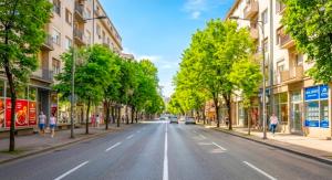 an empty street in a city with buildings at Nexus Apartment in Podgorica +2 photos