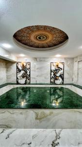 a lobby with a glass table and a ceiling at Zarina Hotels & Hamam in Batumi