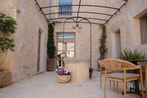 a patio with a fountain and a table and chairs at Bytra Boutique Hotel - Adults Only in Petra