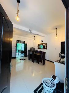 a view of a living room and dining room at Orange Jesmine Unawatuna in Unawatuna