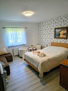 a bedroom with a large bed and a living room at Willa WiK in Rewal