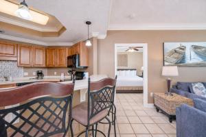 a kitchen and living room with a couch and a bed at Phoenix on the Bay 1211 condo in Orange Beach