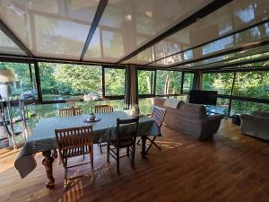 a living room with a table and chairs and a couch at Le chalet Campy in Moustier