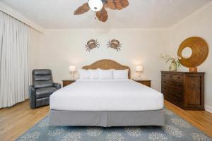 a bedroom with a bed and a chair at Phoenix on the Bay 1326 condo in Orange Beach +43 photos