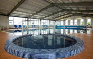 a swimming pool with a large glass floor at Tide & Anchor - Newperran 102 in Cubert