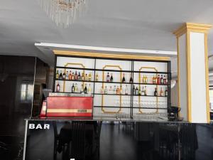 a bar with a lot of bottles of alcohol at Hotel Italia in Golem +14 photos