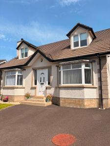 a house with a driveway in front of it at Moyle Manor in Ballycastle