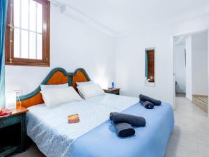 a bedroom with a bed with two towels on it at Cute Las Flores 1i with pool in Costa de Adeje +16 photos