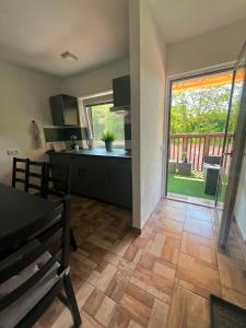 a kitchen and dining room with a large sliding glass door at VilaEva Adršpach Broumovsko in Ruprechtice