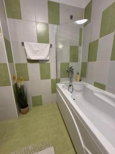 a bathroom with a bath tub and a shower at Dream City Center in Piteşti +4 photos