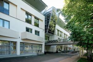an external view of a building with a walkway at Palangos Vetra in Palanga