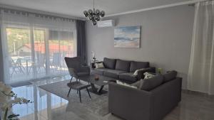 a living room with a couch and a table at Villa Aylen in Mošćenička Draga