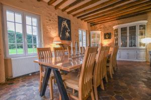 a dining room with a wooden table and chairs at Kermajic 10 in Villiers-Saint-Georges