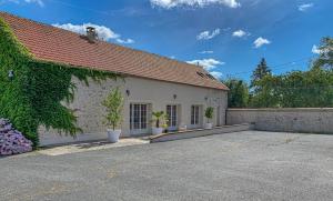 a house with two potted plants in front of it at Kermajic 10 in Villiers-Saint-Georges
