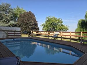 a swimming pool on a deck next to a fence at Kermajic 10 in Villiers-Saint-Georges